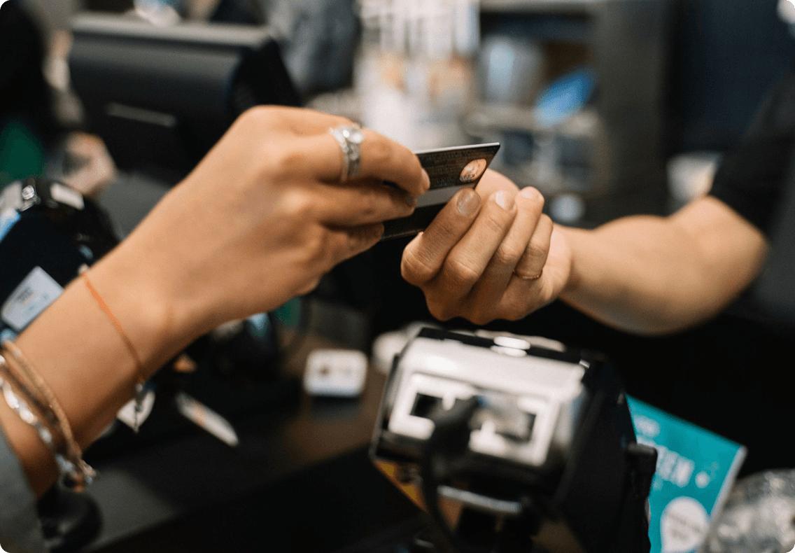 Customer paying with a card at a point-of-sale terminal